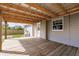 Charming covered back porch with wood flooring, perfect for outdoor relaxation at 200 Summerset Dr, Punta Gorda, FL 33982