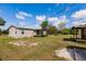 Expansive backyard with a covered porch, shed, and plenty of room for outdoor enjoyment at 200 Summerset Dr, Punta Gorda, FL 33982