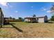 Spacious backyard featuring a covered patio, shed, and lush greenery at 200 Summerset Dr, Punta Gorda, FL 33982