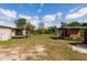 Spacious backyard featuring a wooden shed and a small wooden porch at 200 Summerset Dr, Punta Gorda, FL 33982