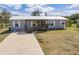 Charming single story home with a wooden porch and well-maintained lawn at 200 Summerset Dr, Punta Gorda, FL 33982