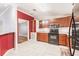Well-lit kitchen with updated appliances, cabinetry, and seamless tile floors at 200 Summerset Dr, Punta Gorda, FL 33982