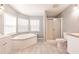 Bright main bathroom featuring a soaking tub, shower, and double sink vanity at 200 Summerset Dr, Punta Gorda, FL 33982