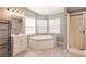 Spacious bathroom featuring a soaking tub, shower, and a single sink vanity at 200 Summerset Dr, Punta Gorda, FL 33982