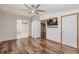 Spacious main bedroom featuring wood floors, a ceiling fan, and an ensuite bathroom at 200 Summerset Dr, Punta Gorda, FL 33982