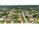 Aerial view displays a home with a pool in a peaceful residential community with lush greenery at 20355 Mount Prospect Ave, Port Charlotte, FL 33952