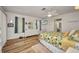 Light and airy bedroom featuring wood floors, a ceiling fan, and an ensuite bathroom at 20355 Mount Prospect Ave, Port Charlotte, FL 33952
