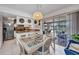 Bright dining area featuring a glass table, rattan chairs, and sliding glass doors to the outdoor patio at 20355 Mount Prospect Ave, Port Charlotte, FL 33952
