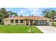Charming single-story home featuring a well-manicured lawn and a welcoming front entrance, blending comfort and curb appeal at 20355 Mount Prospect Ave, Port Charlotte, FL 33952