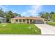 Single-story home with well-kept lawn, decorative features, and an attached garage at 20355 Mount Prospect Ave, Port Charlotte, FL 33952
