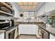 Bright kitchen with stainless steel appliances, granite countertops, white cabinets, and stylish backsplash at 20355 Mount Prospect Ave, Port Charlotte, FL 33952