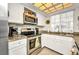 Well-lit kitchen featuring stainless steel appliances, granite countertops, and ample white cabinetry at 20355 Mount Prospect Ave, Port Charlotte, FL 33952
