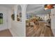 Bright and open living room with wood floors, arched doorway and a large mirror accent wall at 20355 Mount Prospect Ave, Port Charlotte, FL 33952