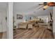 Bright and open living room with wood floors, arched doorway and a large mirror accent wall at 20355 Mount Prospect Ave, Port Charlotte, FL 33952