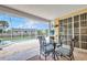 Screened-in patio with an ornate glass-topped table, wrought iron chairs, and a view of the pool at 20355 Mount Prospect Ave, Port Charlotte, FL 33952