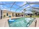 Large pool enclosed by a screened-in patio, surrounded by a spacious deck for lounging and entertaining at 20355 Mount Prospect Ave, Port Charlotte, FL 33952