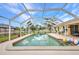 Inviting screened pool area, perfect for relaxation and entertaining, with ample patio space and clear blue water at 20355 Mount Prospect Ave, Port Charlotte, FL 33952