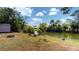 Beautiful backyard featuring a pond, bench, fire pit, and lush greenery, perfect for relaxation at 20407 Albury Dr, Port Charlotte, FL 33952