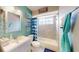 Bright bathroom with shower over tub, a vanity with storage, and nautical themed art at 20407 Albury Dr, Port Charlotte, FL 33952
