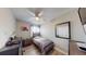 Cozy bedroom with a desk, bed, chair, ceiling fan and wood-look flooring at 20407 Albury Dr, Port Charlotte, FL 33952