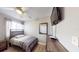 Comfortable bedroom with a television, ceiling fan, closet, and wood-look flooring at 20407 Albury Dr, Port Charlotte, FL 33952