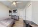 Compact bedroom with a television, desk, closet, ceiling fan, and wood-look flooring at 20407 Albury Dr, Port Charlotte, FL 33952