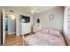 A cozy bedroom includes a ceiling fan, closet, ensuite bathroom, and wood-look flooring at 20407 Albury Dr, Port Charlotte, FL 33952