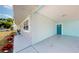 Side view of a house featuring a covered entry, stone accents, and a blue front door at 20407 Albury Dr, Port Charlotte, FL 33952