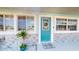 Welcoming front entry with attractive blue door, decorative wreath, and stone veneer accents at 20407 Albury Dr, Port Charlotte, FL 33952