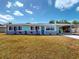 Charming single story home featuring a quaint carport, cheerful exterior color scheme, and low maintenance landscaping at 20407 Albury Dr, Port Charlotte, FL 33952