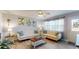 Cozy living room featuring stylish furnishings, bright windows, and modern ceiling fan at 20407 Albury Dr, Port Charlotte, FL 33952