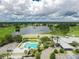 Stunning aerial view featuring a community pool, beautiful lake, and golf course at 2087 Lynx Run, North Port, FL 34288