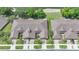 An aerial view displays the property's unique roofline, lush landscaping, and proximity to a serene pond and natural surroundings at 2087 Lynx Run, North Port, FL 34288