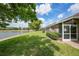 Lakeside backyard with manicured lawn and screened patio at 2087 Lynx Run, North Port, FL 34288