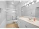 Well-lit bathroom featuring shower/tub combo, toilet, and a vanity with countertop space at 2087 Lynx Run, North Port, FL 34288