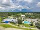 An aerial view showcases the community's luxurious amenities, including a pool, golf course, clubhouse, and pristine landscaping at 2087 Lynx Run, North Port, FL 34288