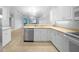 Well-lit kitchen with white cabinetry, modern appliances, and views into the dining and living areas at 2087 Lynx Run, North Port, FL 34288