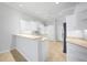 Bright kitchen featuring white cabinetry, appliances, and a breakfast bar for extra seating at 2087 Lynx Run, North Port, FL 34288