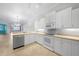 Bright kitchen with white cabinets and modern appliances with an opening to the dining area at 2087 Lynx Run, North Port, FL 34288