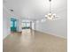 Spacious living room featuring tile flooring, ceiling fan, and sliding glass doors to the outside at 2087 Lynx Run, North Port, FL 34288