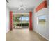 This living room features large windows with views of the lake and the patio at 2087 Lynx Run, North Port, FL 34288