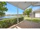 Covered patio with a view of a lake and greenery at 2087 Lynx Run, North Port, FL 34288