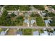 An aerial view of a residential neighborhood, with lush greenery and houses with private pools at 2113 Barksdale St, Port Charlotte, FL 33948
