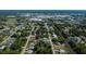 The aerial view showcases the property in a quiet residential area with mature trees and close to community amenities at 2113 Barksdale St, Port Charlotte, FL 33948