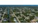 An aerial view of the property in a neighborhood with lush greenery and canal access at 2113 Barksdale St, Port Charlotte, FL 33948