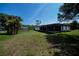 Expansive backyard showcasing the shed, screened-in porch, and ample green space, perfect for outdoor enjoyment at 2113 Barksdale St, Port Charlotte, FL 33948