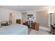 A bedroom is displayed, furnished with a bed, a desk, and a television at 2113 Barksdale St, Port Charlotte, FL 33948
