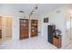 Bonus room with tile floors, track lighting, and bookshelves for storage and display at 2113 Barksdale St, Port Charlotte, FL 33948