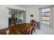 Bright dining room features a large wooden table, sliding glass doors to a sunroom, and a large window at 2113 Barksdale St, Port Charlotte, FL 33948