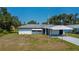 Charming single-story home featuring a carport and an expansive front yard at 2113 Barksdale St, Port Charlotte, FL 33948